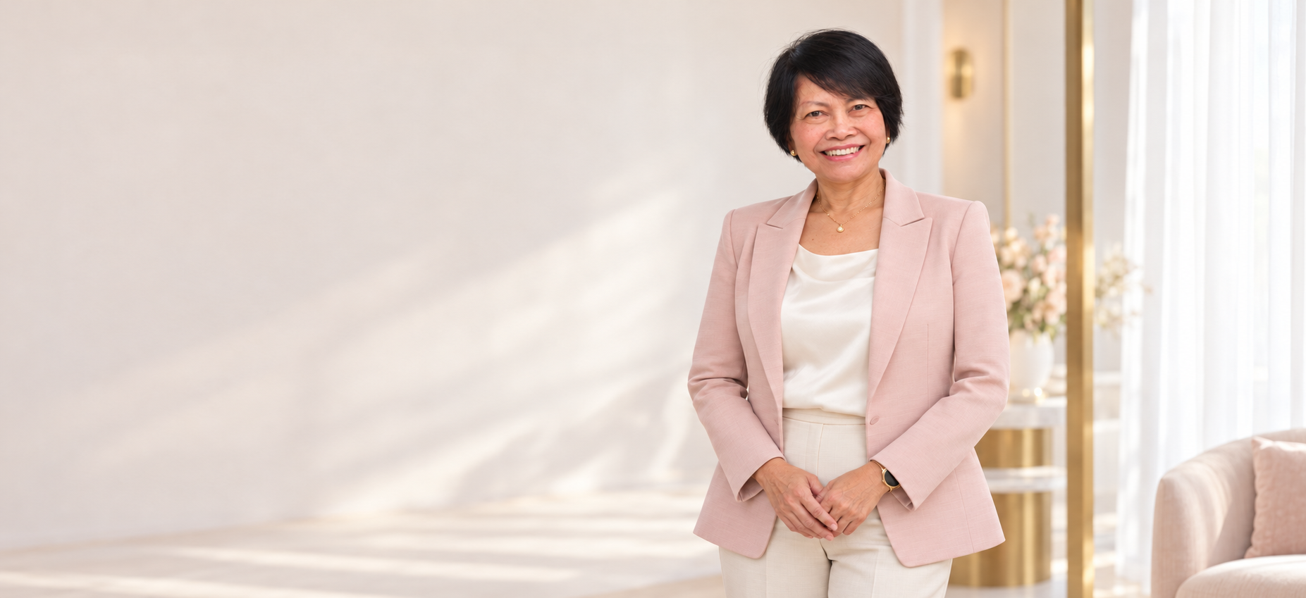 Dr. Apakorn in a warm cream, blush pink and gold setting